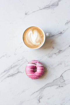 iced donut with striped pattern on a marble background
