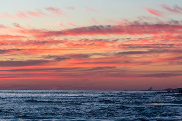 Red and orange sunset clouds at the beach