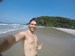 Brazilian Man taking a selfie in the Beach