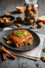 Walnut cake with grated apple layer and caramel toping