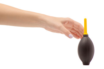 Female hand holding a pear to clean the camera