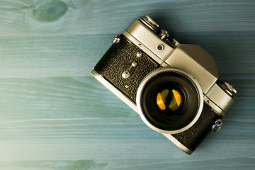 Vintage photo camera on a wooden table