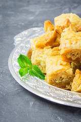 baklava turkish traditional delight on a dark wood background. toning