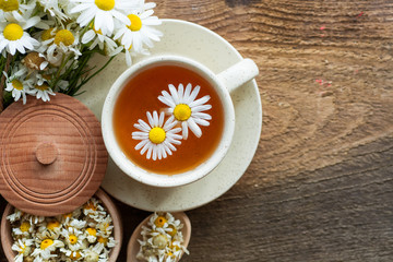 cup of herbal chamomile tea with camomile dry blossoms, dried camomile flowers. doctor treatment and prevention of immune concept, medicine - folk, alternative, complementary, traditional medicine 