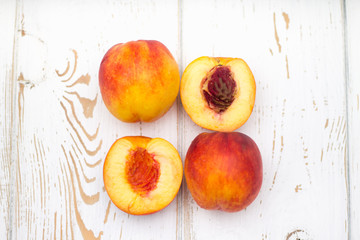 a lot of fresh peaches on a white table. Top view.