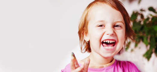 Beautiful child girl sincerely smiling and laughing. Freedom of emotions, happy childhood joy concept.