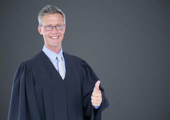 Male judge thumbs up against grey background