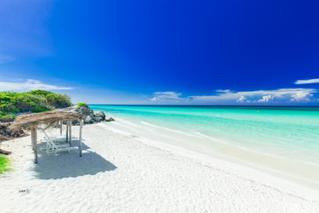 stunning, amazing inviting view of tropical white sand beach and tranquil turquoise ocean on dark...
