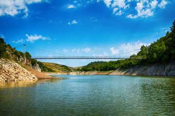 Fototapeta na wymiar Uvac, Serbia august 03, 2017: Landscape with pedestrian bridge at river Uvac gorge