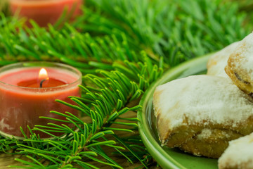 Christmas decoration - pine branch with red candles and Christmas biscuits
