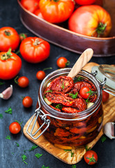 Sun dried tomatoes with garlic and olive oil in a jar