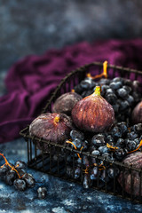Fresh figs and purple grape in basket