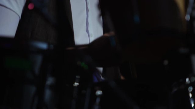  Close up drummer using drum pedal, playing at live music event