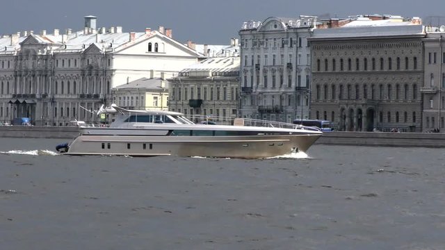 Passenger excursion ships on the Neva river past the Hermitage. The tourist season in the Historic city Museum.