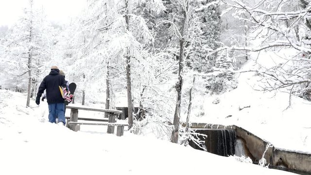Footage of snowboarders man and girl adventure at mountain backcountry.