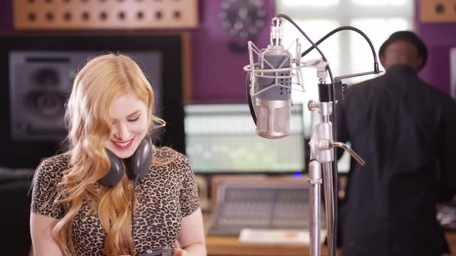  Female vocalist in recording studio using mobile phone for video call
