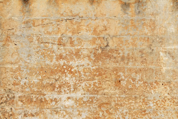 Weathered and stained orange plaster block wall
