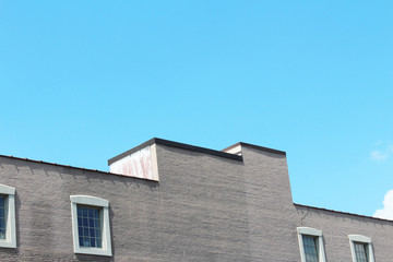 Stepped top of a commercial building with a row of windows
