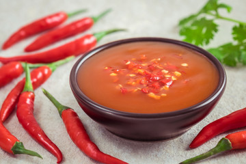 Chili sauce in bowl and fresh chili