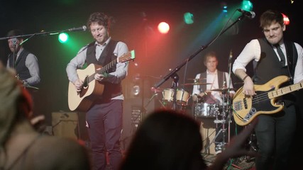  Live band performing in front of an enthusiastic crowd at music event. - Powered by Adobe