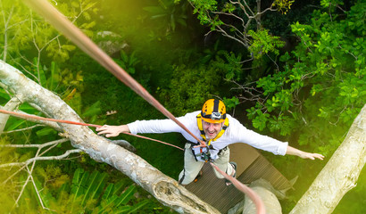 Descent on a rope from a tree. Rope park . Entertainment on vacation. Thailand.