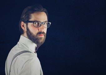 Millennial man looking over shoulder against blue background