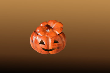 Halloween pumpkin made of wood Concept isolated on brown background and clipping path