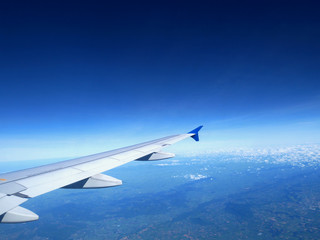Plane wing on the sky with sunset and cloud