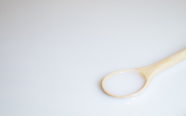 Sour cream in wooden spoon, milk in wooden spoon, yogurt in wooden spoon