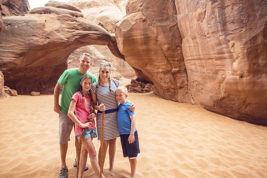 Family hiking and sightseeing together at Arches National Park 