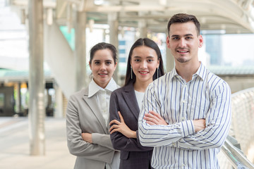 Group of young caucasian business people in the city with successful and confident feeling