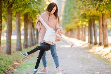 Family of mom and kid outdoors having fun in autumn day