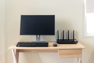 Office table with wifi router and computer and supplies