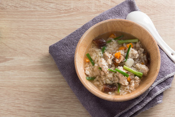 Asian congee with pork in white bowl.