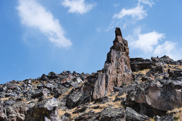 Fototapeta premium High-mountainous sharp rocks against the blue sky and white clouds. Caucasus