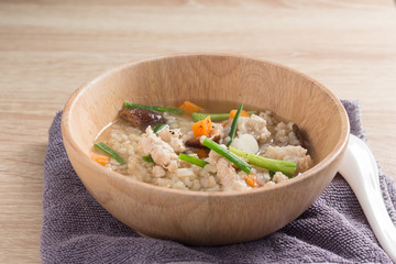Asian congee with pork in white bowl.