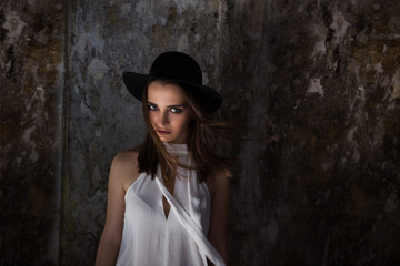 A girl in a white blouse, with tare destroyed building. Helouin.