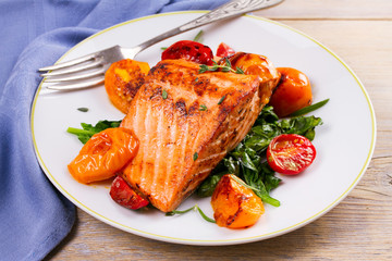 Salmon fillet with spinach, tomatoes and herbs, horizontal