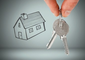 Hand Holding key with house drawing in front of vignette