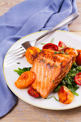 Salmon fillet with spinach, tomatoes and herbs, vertical