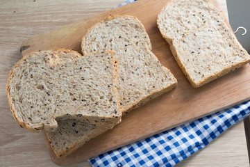 Top view of sliced wholegrain bread on a wooden table.