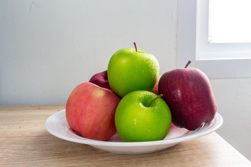 Ripe Green and Red apples on white table background.