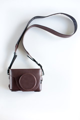 Brown camera case on the white background