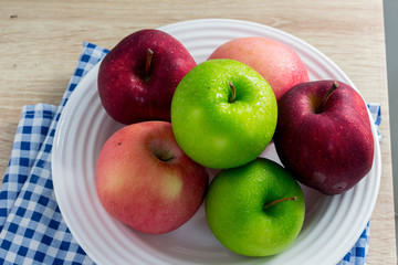 Ripe Green and Red apples on white table background.