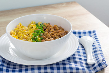 chicken and egg with sauce over rice