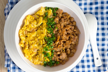 chicken and egg with sauce over rice