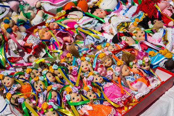 Fototapeta na wymiar Dolls toys handmade souvenirs at the exhibition of folk arts