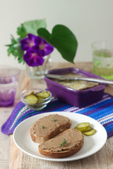 Homemade liver pate with bread and canned cucumber. Rustic style, selective focus.