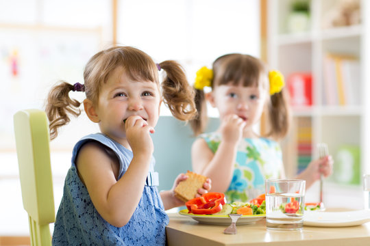 Cute little children eating food at daycare