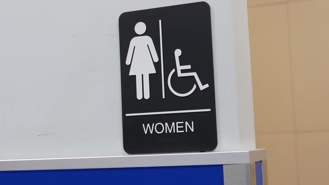 Motion of women and disable washroom logo on wall